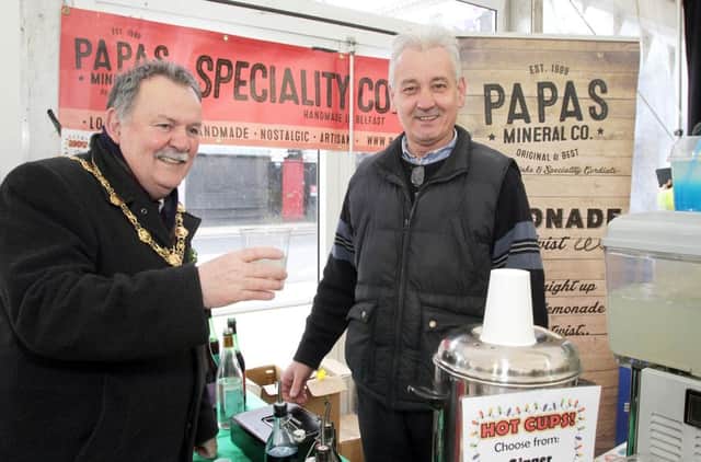 The Mayor Councillor Maoliosa McHugh, samples a soft drink from the Papas Mineral Co stall owned by Tom McGuire,  after he officially opened the Legenderry Food Festival in Guildhall Square, part of  the  St. Patricks Day celebrations. 0318-8776MT.