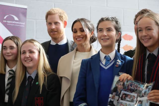 Prince Harry and Megan Markle pictured with local schoolkids.