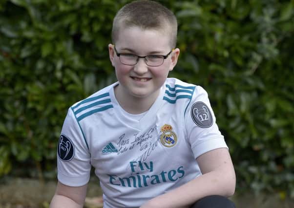 Ten years-old Jack Lynch-Bradley, from Inch Island, with the personalised signed Real Madrid shirt he received from Cristiano Ronaldo. DER138GS037