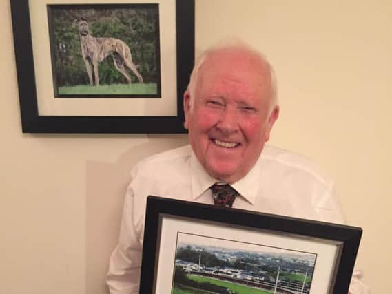 Robert Bonner with a framed picture of the old and new Brandywell Greyhound tracks, presented to him by his niece.