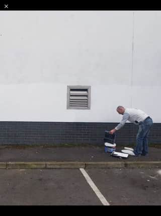 Sinn Fein activist painting over the graffiti at the weekend.