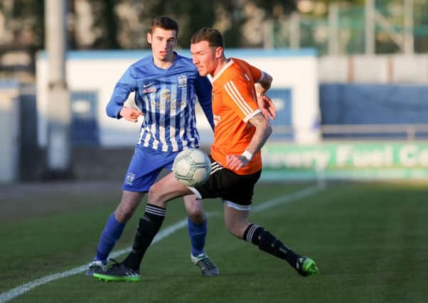 Newry City's Mark McCabe (Blue & White Stripes) headed home a late winner at Institute, on Saturday.