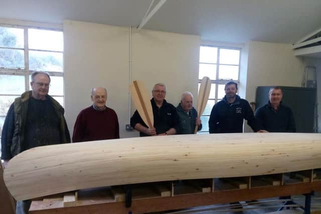 The Men's Shed members with their Canadian 'Laker' canoe.