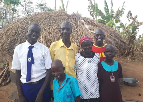 Daniel (on left) with his family in Uganda. Photo Mark Stedman.
