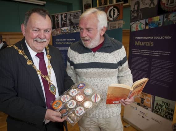 Peter Moloney and Mayor Maoliosa McHugh looking at a selection of items from the Peter Moloney Collection.