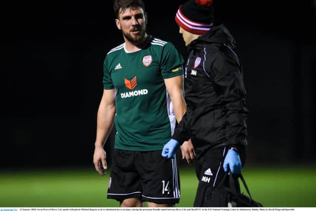 Gavin Peers, pictured with physio Michael Hegarty after sustaining an injury in the pre-season friendly against Sheriff YC.