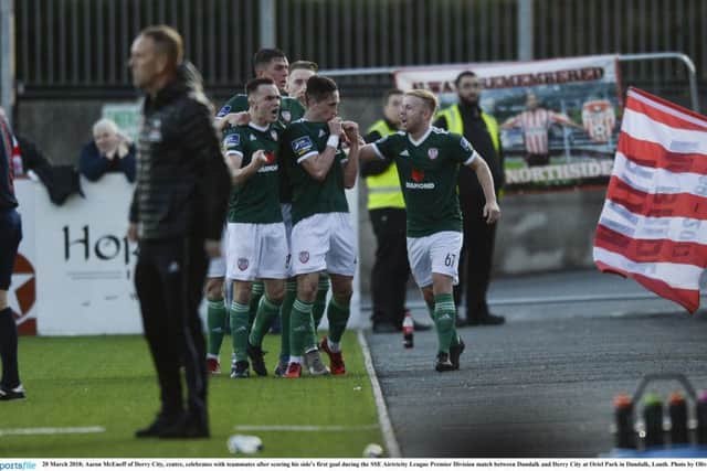 Aaron McEneff of Derry City, centre, celebrates with teammates after scoring his side's first goal during the SSE Airtricity League Premier Division match between Dundalk and Derry City at Oriel Park in Dundalk.