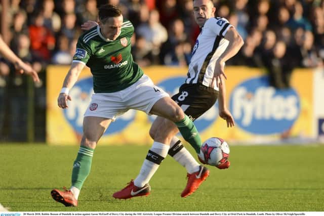 McEneff shields the ball under pressure from Robbie Benson of Dundalk.