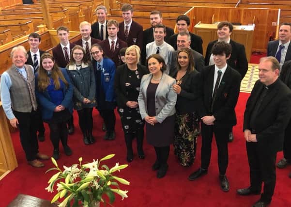 Reverend David Latimer with Sinn Fein President Mary Lou McDonald with invited guests including local school pupils, at First Derry Church.