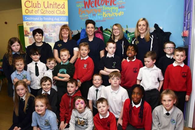 Staff members, from left, Ashling Riddles, Louise Stevenson, manager, Leanne McGahan, administrator, Laura Watson and Sarah Doherty, pictured with children who enjoyed returing to the newly refurbished Club United Out of School Club. DER1618-105KM