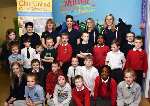 Staff members, from left, Ashling Riddles, Louise Stevenson, manager, Leanne McGahan, administrator, Laura Watson and Sarah Doherty, pictured with children who enjoyed returing to the newly refurbished Club United Out of School Club. DER1618-105KM