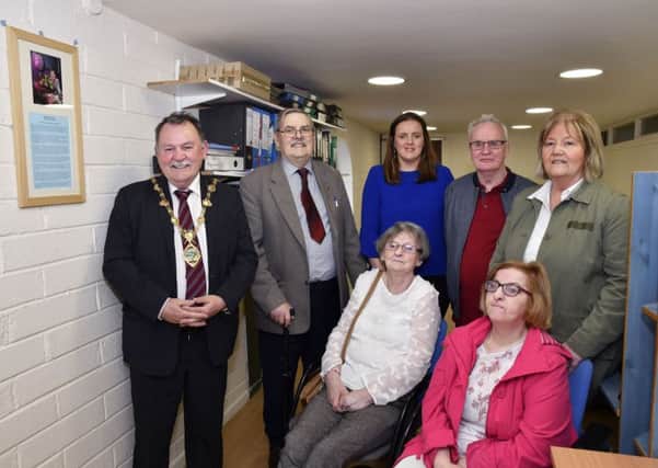 The Mayor, Councillor Maoliosa McHugh unveling a plaque at the opening of the Kathleen McCrea Suite at Destined, Foyle Road, on Wednesday. Included are, from left, seated, Bernadette Bradley and Jackie McBride, standing, George Glenn, Roisin Doherty, Robert Blakley and Jackie Garnon. DER1718-144KM