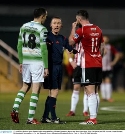 Referee Derek Tomney in discussion with Joey OBrien of Shamrock Rovers and Rory Patterson of Derry City during last Friday night's game at Brandywell.