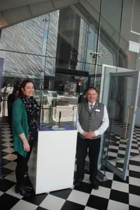 Curator with Derry City and Strabane District Councils Museum and Visitor Service, Roisin Doherty pictured with Titanic Hotel concierge Gerry McKeever unveiling the Laurentic Bell at the entrance of the building where visitors will be able to view it until the end of July.