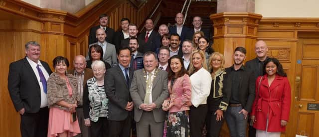 Lai and Stan Lee, proprietors of Mandarin Palace, recent winners of the Best Chinese Restaurant in Ireland award, pictured with Councillor MaolÃ­osa McHugh, Mayor of Derry City and Strabane, at a mayoral reception, held during the week in the Guildhall. Included in the photograph are family, friends and staff from the restaurant. DER1818GS16