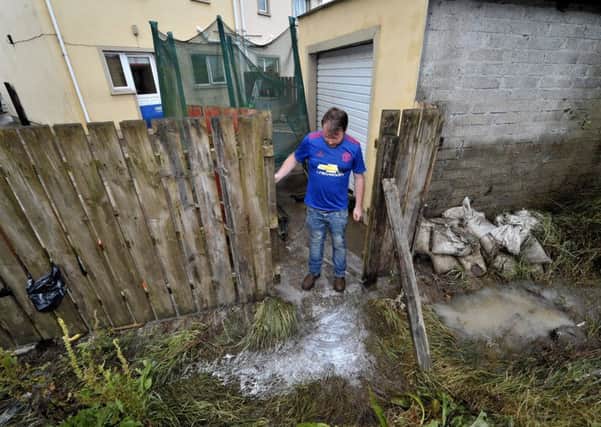 Gerald Gallagher examines the raw sewage at the rear of his house in Parc An Grianan, Burnfoot, after the river bank burst during flooding in August.
