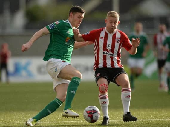 Derry City's Nicky Low nips in front of Cork's Garry Buckley during the first half at Brandywell Stadium.