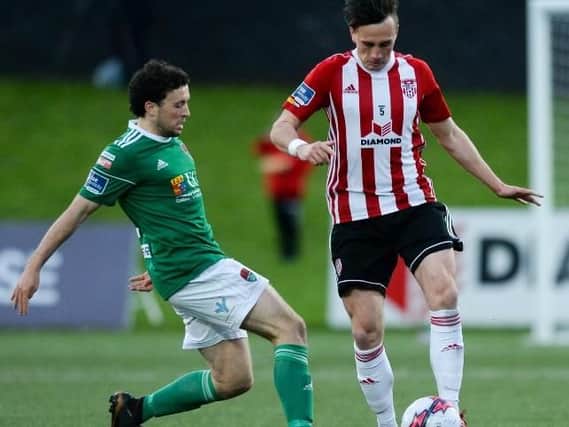 Derry City's Aaron McEneff skips away from Cork City's Barry McNamee.