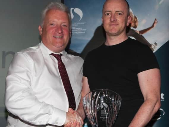 Stephen Maguire presenting the Sports Star of the Year award to Trevor McGlynn, husband of recipient Ann Marie McGlynn, Strabane at the DCSDC Annual Sports Awards.