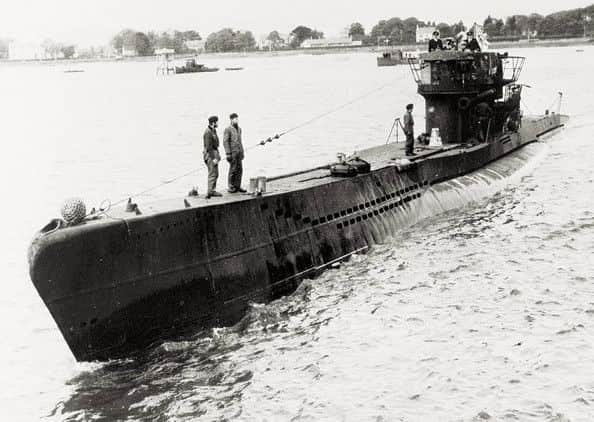 One of the u-boats surfacing on the River Foyle during the surrender.