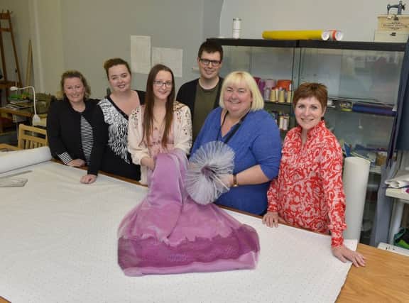 Julie-Ann Coll (second from left) and Catherine Cooke (second from right), daughter and-mother from Derry, pictured with the dress  and hat Catherine will be wearing at the wedding of Prince Harry and Meghan Markle tomorrow. Included in the picture are the design team, from the Fashion Hub, Deirdre Williams, Co-ordinator, Nicole Scott, Paul Stafford and Elaine Duffy. DER2018GS033