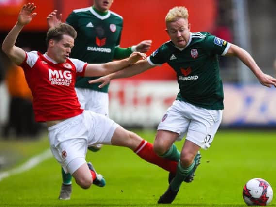 St Patrick's Athletic defender Simon Madden brings down Derry City's Nicky Low.