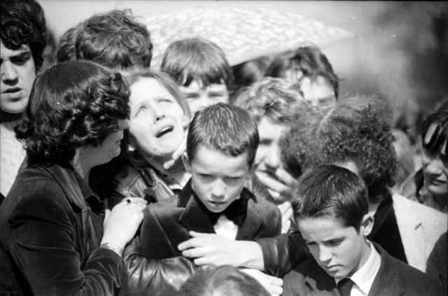 April 1982... Stephen McConomy's mother and younger brothers pictured at his funeral.