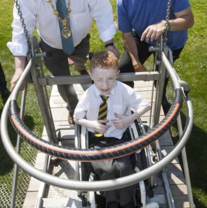 MAYOR OPENS NEW PLAY AREA. . . .The Mayor of Derry City and Strabane District Council, Maoliosa McHugh pictured with young Cianan Campbell (Model PS), one of the first children to try the new wheelchair-friendly swing at Brooke Park on Wednesday afternoon. On right is Dalton Keogh. The Â£135k project, including a funding contribution of Â£45k from the Department for Communities, was completed by contractors All Play Ireland and includes a wheelchair friendly swing, a wheelchair see-saw and carousel and a hexagonal rocking plate.Â (Photos: Jim McCafferty Photography)