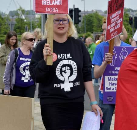 Pro Choice supporters hold placards at the abortion rights campaign group ROSA, Reproductive Rights Against Oppression, Sexism and Austerity rally at Guildhall Square on Thursday evening last. DER2218G027