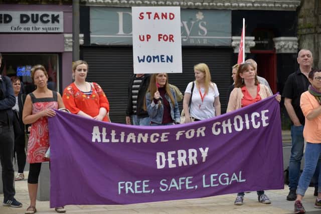 Pro Choice supporters, from the Alliance for Choice Derry, at the abortion rights campaign group ROSA, Reproductive Rights Against Oppression, Sexism and Austerity rally at Guildhall Square on Thursday evening last.  DER2218G024