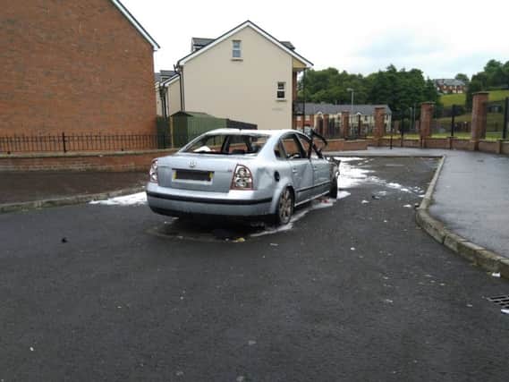 The burned out car at Dove Gardens in the Bogside.