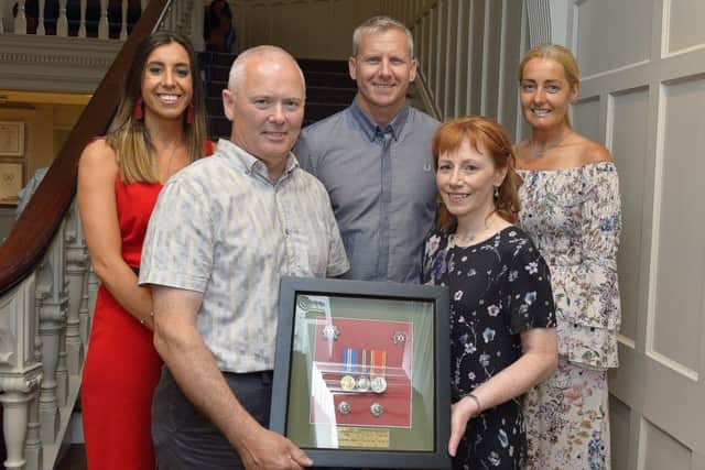 Tracy Deans, NIFRS Area Business Manager, presents Station Commander Kevin Lynch with a momentum at his recent retirement party held in the Bishops Gate Hotel. Included in the photograph are Elena Figini, Area Commander Jonathan Tate and Joanne Scahill. DER2318GS041