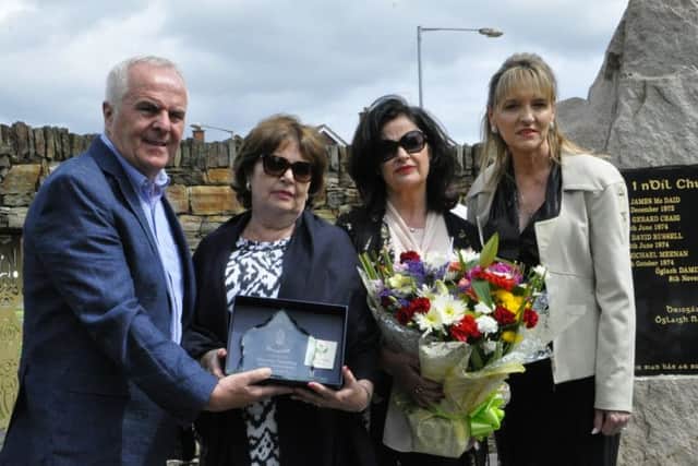 Sinn FÃ©in Foyle MEP Martina Anderson and Foyle MLA Raymond McCartney making a presentation to Dennis sisters Claire and Paula