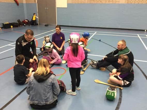 James Walsh and Aaron McBrearty of Na Magha and Brónagh McCarron of Foyle Down Syndrome Trust pictured with a small group of the participants.