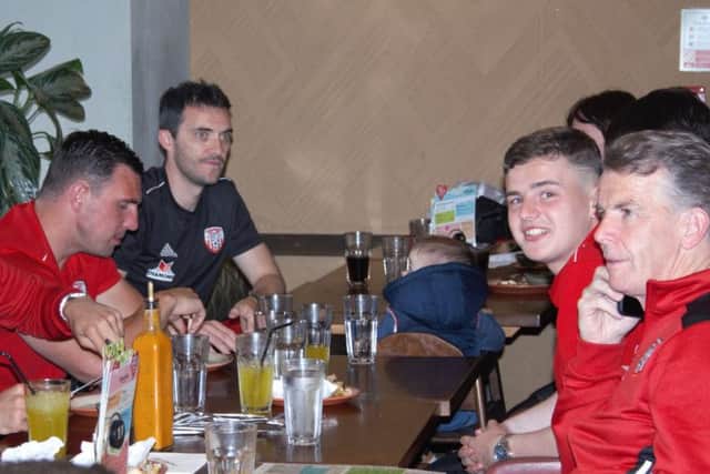 Derry City players and management pictured at the recent "takeover" at Nando's Restaurant as they gathered financial support for Cancer Research.