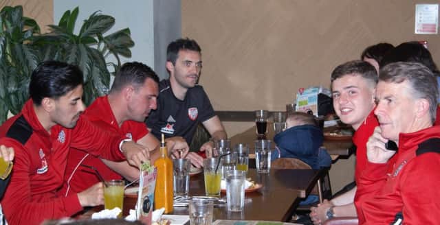 Derry City players and management pictured at the recent "takeover" at Nando's Restaurant as they gathered financial support for Cancer Research.