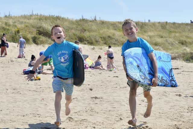 Surfing brothers eight-year-old Jack and Oisin Quinn (9), from Derry, had a great day in the sunshine at the Shorefront beach, Buncrana , yesterday afternoon. DER2618GS051