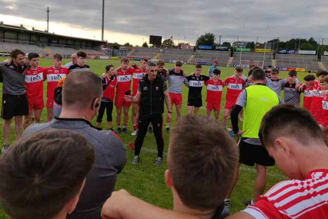 Derry manager Paddy Campbell talks to his players after Sunday's victory.