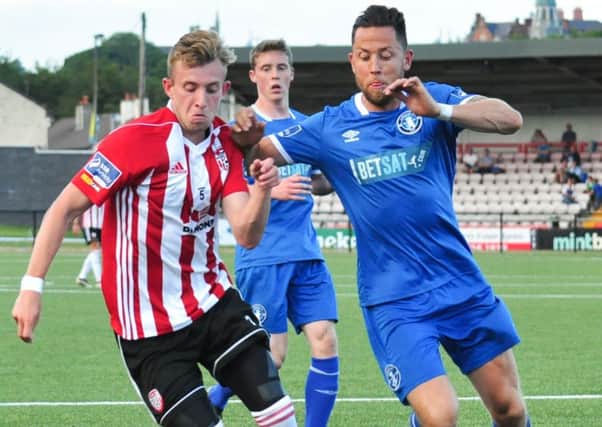 Derry City striker Ally Roy tussles with Limerick defender Billy Dennehy, during Friday night's match.
