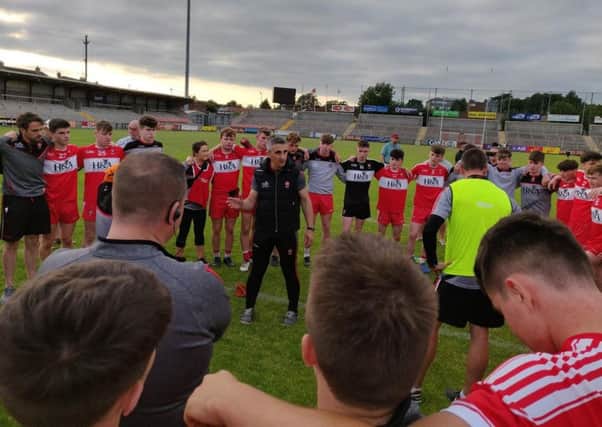 Derry manager Paddy Campbell talks to his players aftertheir semi-final victory over Tyrone.