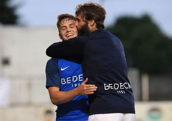 MATCH-WINNER . . . Josh Daniels is embraced by manager, Gary Hamilton after the match.