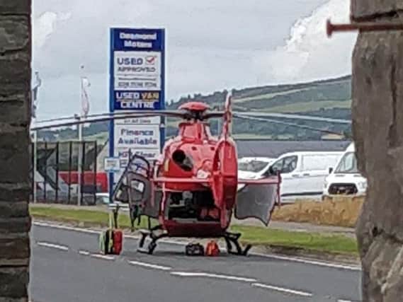 The Northern Ireland Air Ambulance at the scene of the collision in Derry.