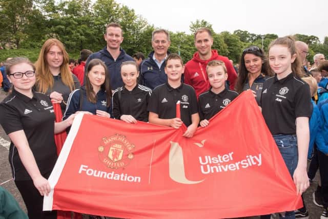 (L-R) Aine Lavery, volunteer; Paul Doherty, Sports Development Officer, Ulster University, Magee campus; Nigel Dobson, Head of Sports Services, Ulster University; Tom Oldbury, Manchester United Foundation and Brenda Harkin, Volunteer with school pupils Eimear Jennings, Laura Kincaid, Aimee McCool, Mackenzie Mcintyre, Caolan Deane and Roisiona Moran at the Foyle Cup parade.