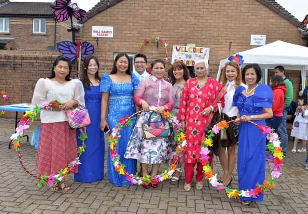 Margret Cunningham pictured with Pilipino guests at the recent 'Welcome to Our World' Big Lunch at McFarland Way. DER2918GS001