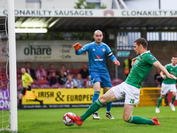 Cork City's Garry Buckley slides home their third goal at Turners Cross tonight.