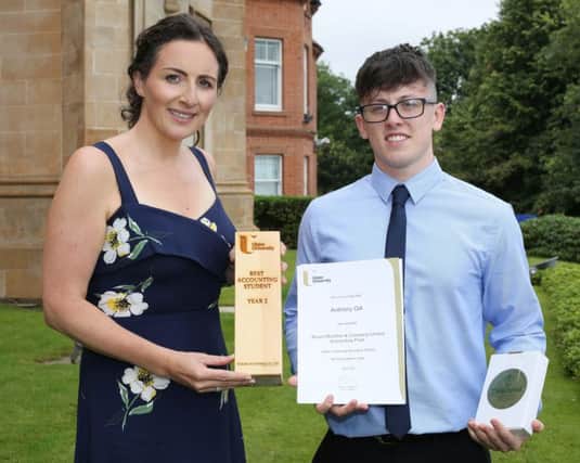 Anthony Gill receives his award from Claire Scott McAteer, Ulster University Business School.