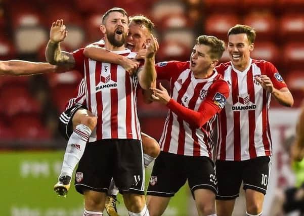 Derry City players Dean Shiels, Ronan Hale and Ben Fisk celebrate with match winner Rory Patterson.