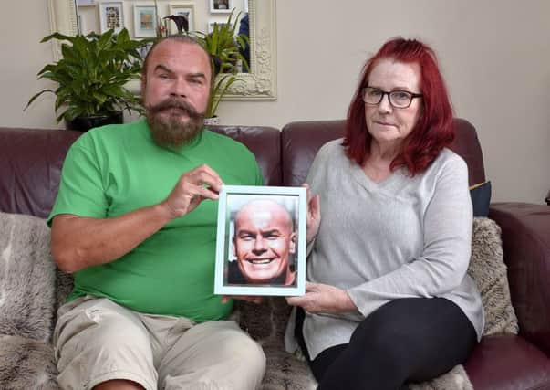 Jennifer and Vincent Coyle pictured with a photograph of their son the late JP Coyle who died suddenly on 19 February this year. A charity walk in memory of JP will take place on 11th August next. DER3118GS002