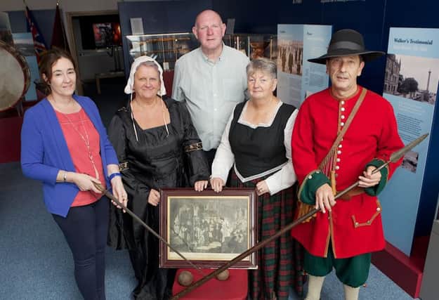 Roisin Doherty, curator, Museum Services, DCSDC, handing over a number of items from the 17th century which will go on display at the Siege Museum. Included are Billy Moore, Siege Museum, Norman Rosborough, Donna Best and Valerie Moore (all in period costume).  (Photo - Tom Heaney, nwpresspics)