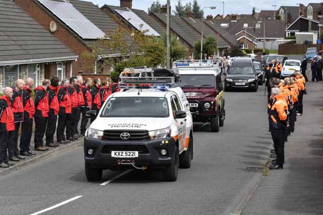 Volunteers from Foyle Search & Rescue and North West Mountain Rescue form a guard of honour at the funeral of Uel Hamilton on Tuesday. DER3218-140KM